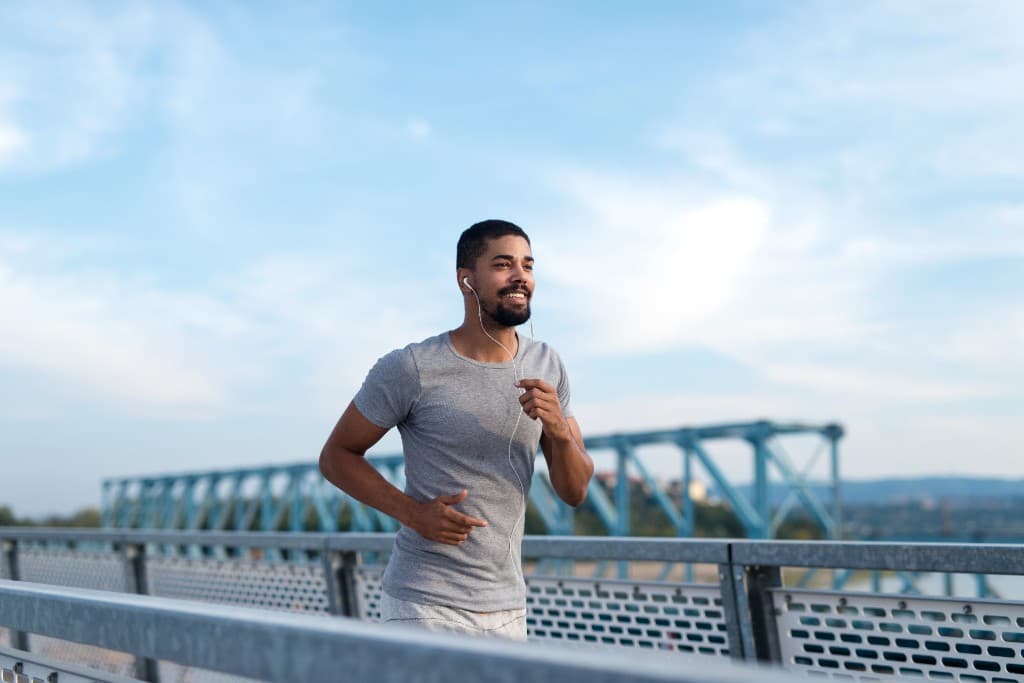 Athlete running outdoors as part of an active men's health lifestyle